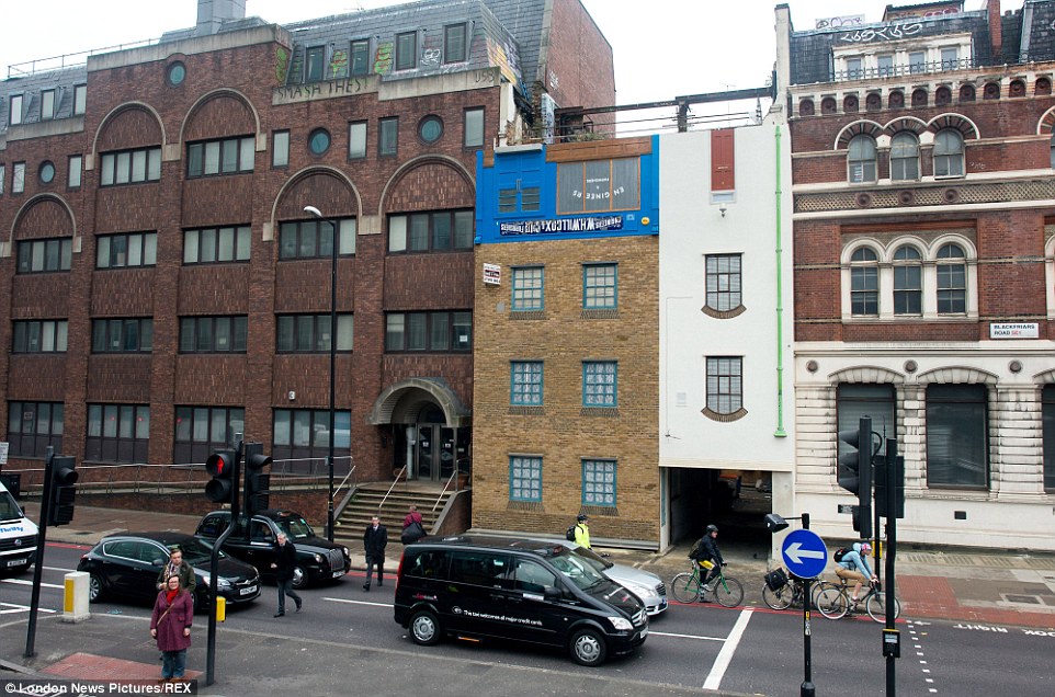 Flip side: This former livery stables on Blackfriars Road in London appeared to have been flipped on its head in another of Mr Chinneck's artworks