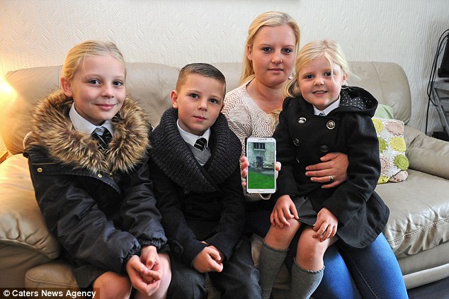 Amy Harper, pictured with her children Maycey, nine, Georgie, six and Scarlett, four, captured the chilling image on her mobile phone on a day trip to Dudley Castle