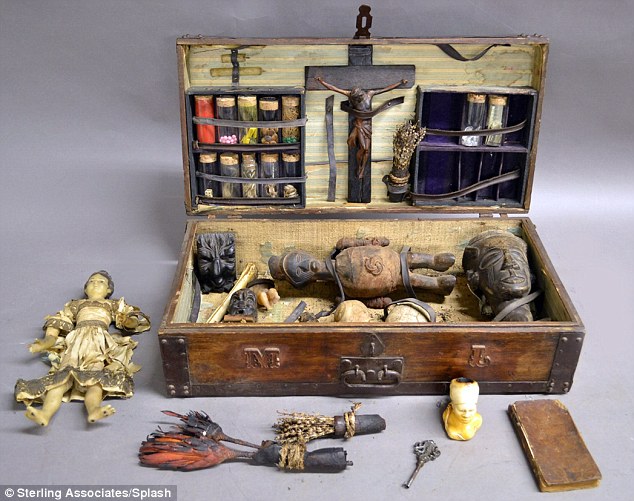 Superstitious: A voodoo box (pictured) from the 1800s - complete with 'hexing paraphernalia', a human skull, a wax doll and chilling photos of infants from post-mortem records - will also appear at the auction