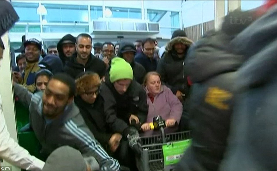 Hundreds of people push through the doors of Asda in Wembley, north London, this morning in a bid to get their hands on a bargain 