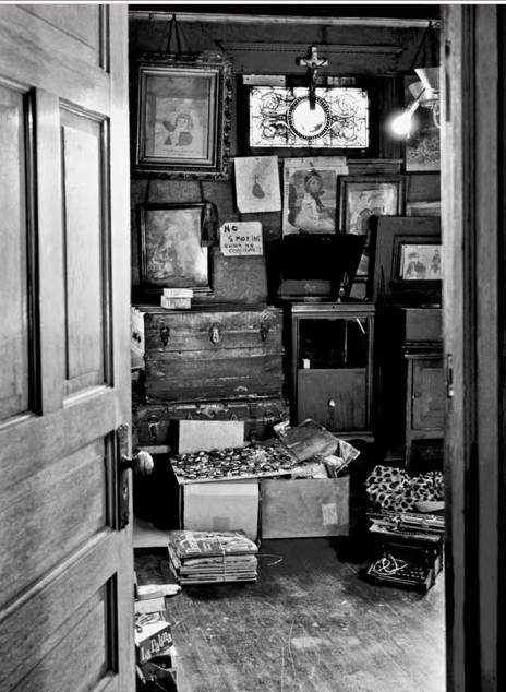 Darger's room, full of his writing, artwork and collections.