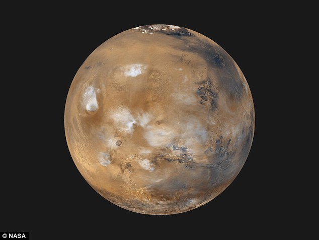 Back in 2011 the scientist first postulated that the red colour on Mars (pictured) could have been due to a naturally occurring thermonuclear explosion - but now he thinks it was caused by an intelligent alien race