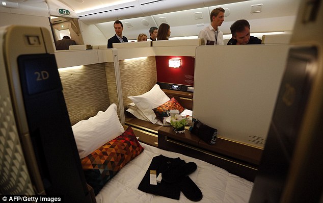 Journalists tour the first class cabin of a Dreamliner, which enters commercial service in February