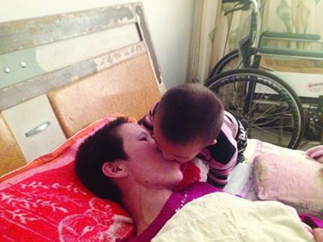 A son's love: Gao Qianbo, two, helpfully chews up mother Zhang Rongxiang's food and feeds it to her mouth to mouth