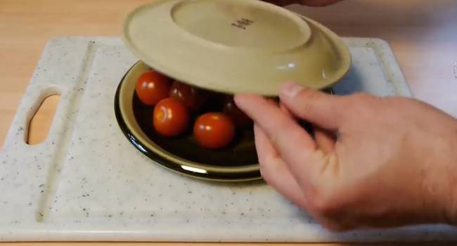 3. 料理時要對切小番茄總是很頭痛的一個步驟，但你可以把小番茄放在兩個盤子之間，盤子之間要留個小縫隙。