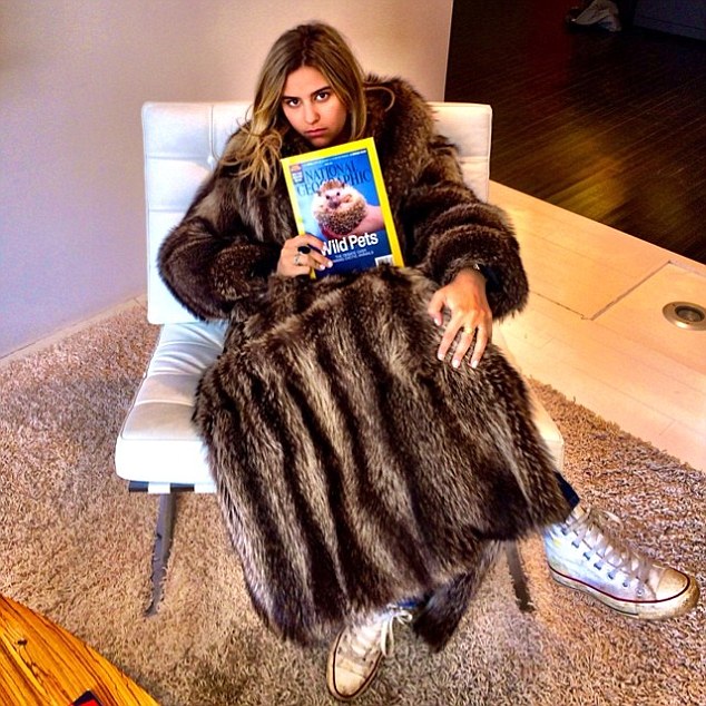 Elsewhere on the site are images of Alex modelling what appears to be a full-length fur coat