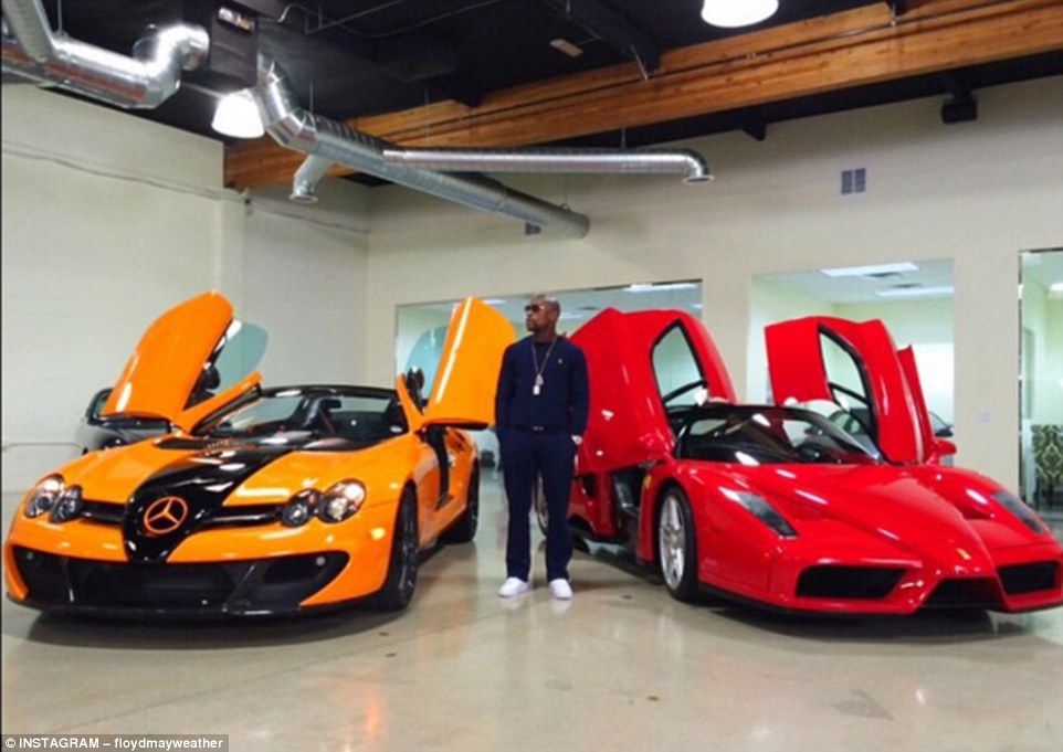 Mayweather while out shopping for cars late last year, flanked by a Mercedes and a Ferrari