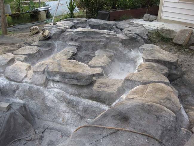 The rocks were then made with latex and mixed colored concrete. He shaped them with a trowel.