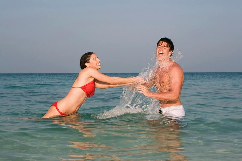 Here are a young couple playing in the sea...