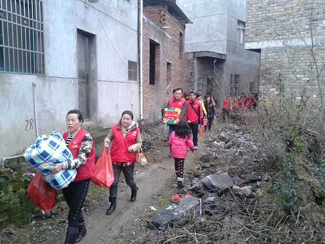 Here to help: Volunteers touched by Su's plight have rushed to her village to start the New Year party