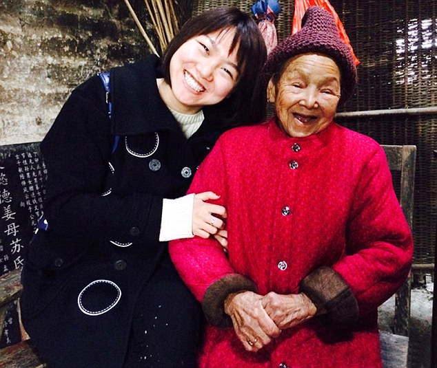Over the moon: Su Guiying (right) with one of dozens of people who have come to share New Year with her