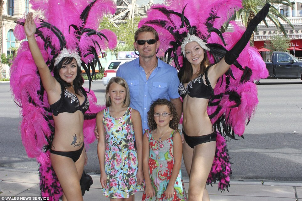 The family went on 36 different journeys by air, pictured with burlesque dancers during their stay in Las Vegas, Nevada