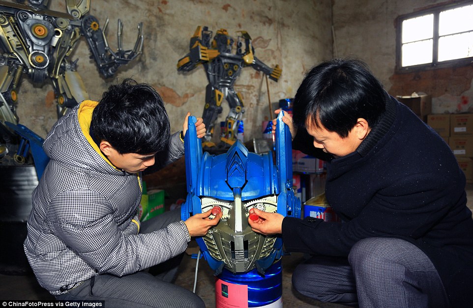 Zhilin and his son have worked together to produce the models and are shown here making an Optimus Prime replica Transformer