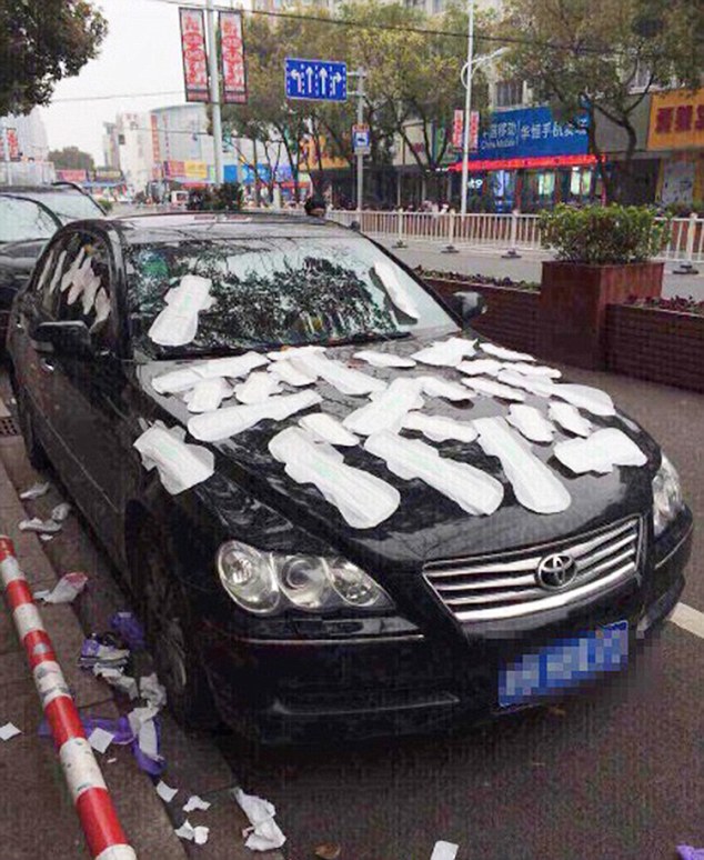 Aftermath:  Li Tan went to the shop and bought 30 sanitary towels before sticking them to her boyfriend's car in front of stunned passers-by
