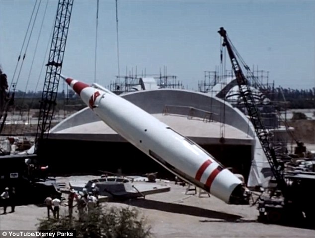 The Rocket to the Moon is lifted into place in front of the futuristic Tomorrowland attraction