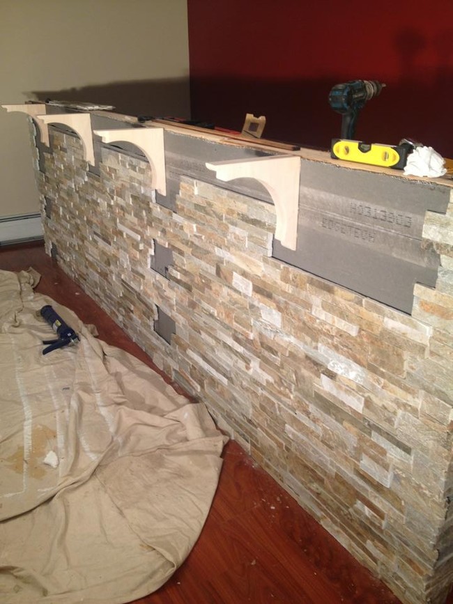 His next step was adding stonework to the front of the bar.