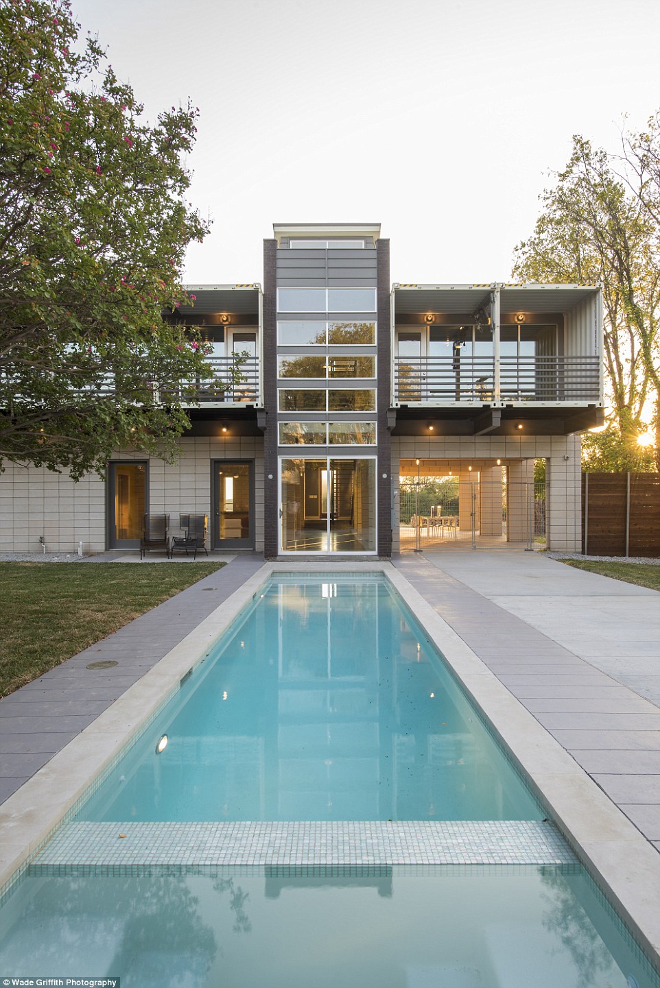 The 3,700 sq ft three-bedroom home, dubbed 'PV14,' boasts a 40ft long swimming pool on the ground floor that reflects the two-story glass-paneled tower, also built out of the containers 