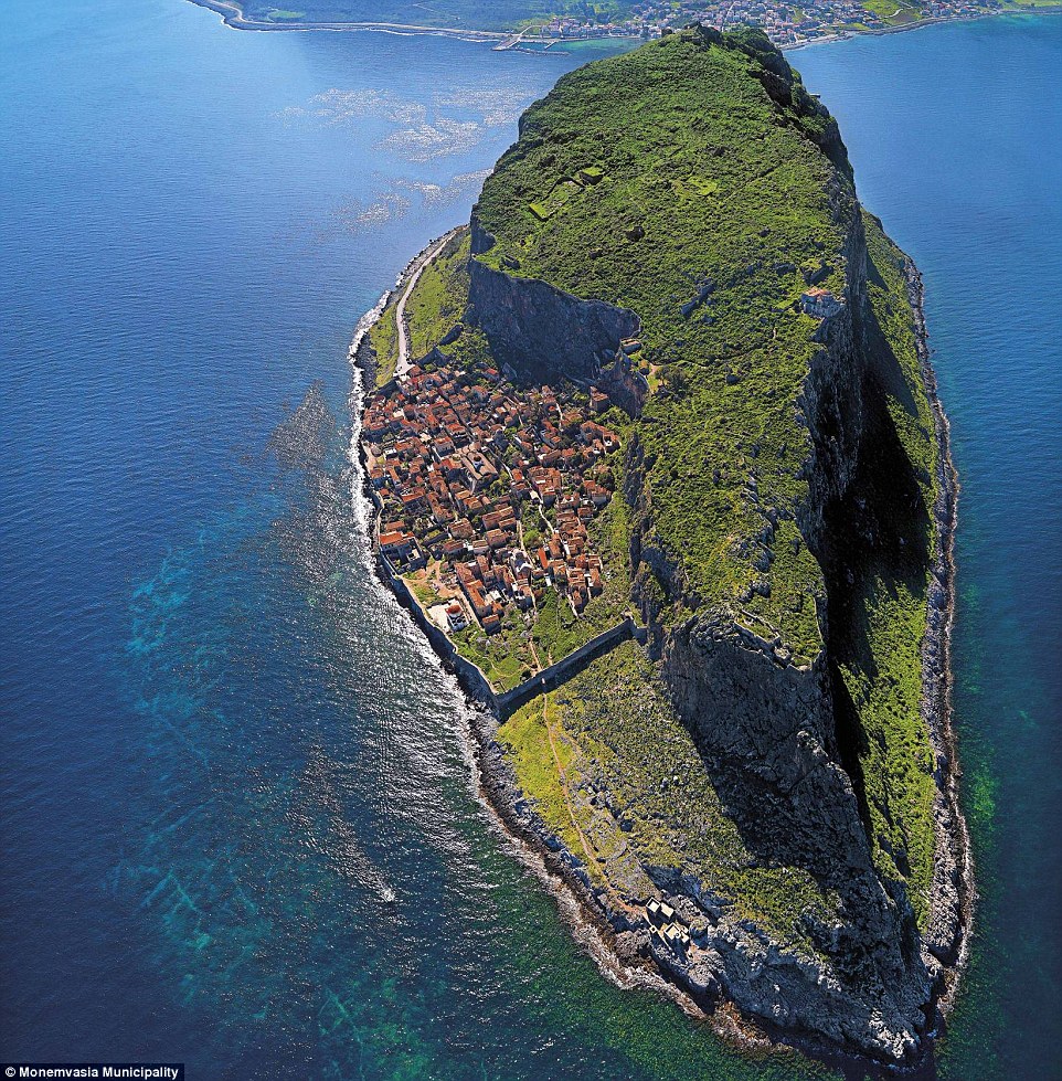 Hidden behind a rock! This tiny settlement is concealed from the Greek coastline behind a giant rock on the island 