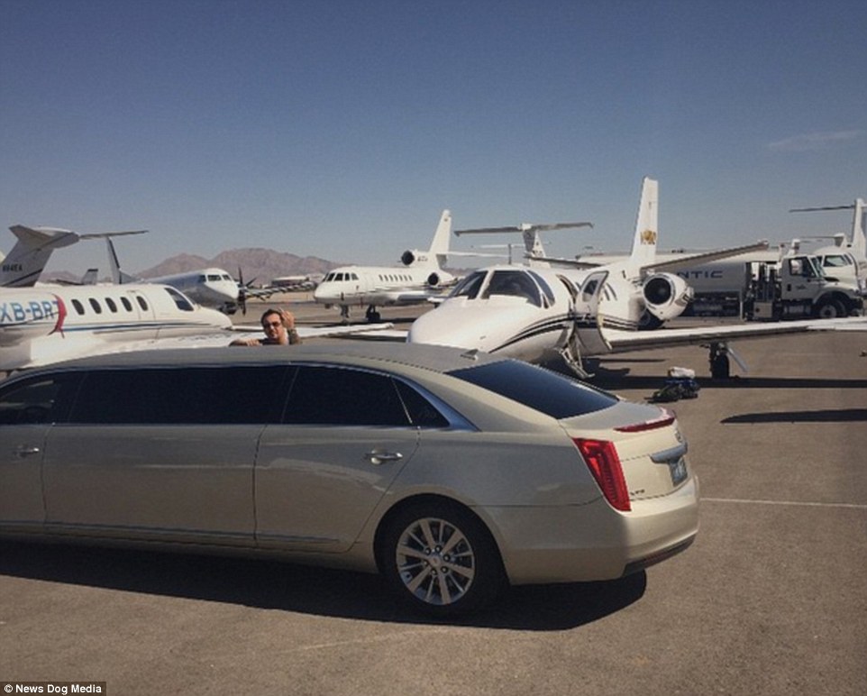 Airfield: The 42-year-old poses at the door of a limo in front of dozens of private jets in another extravagant photo shared with his following