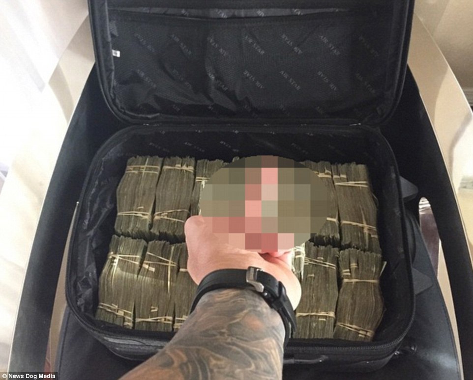 Rude gesture: The tattooed arm of Toutouni is visible as the billionaire swears at a suitcase full of cash in this Instagram post