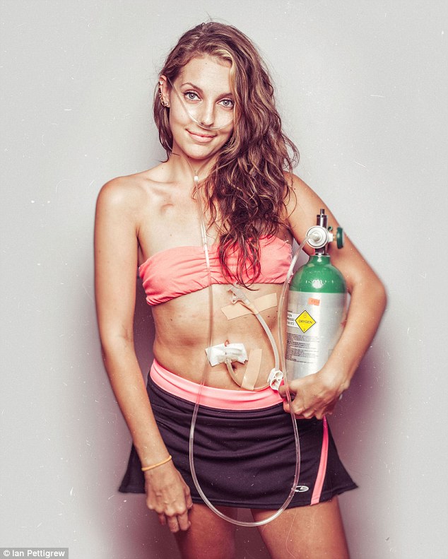 Beautiful fighter: Ian Pettigrew, from Ontario, Canada, photographed this woman with cystic fibrosis holding her oxygen tank as a part of his second book, Salty Girls, which aims to bring awareness to the disease