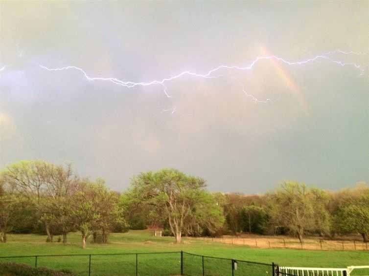 Lightning and a rainbow occurring at the same time.