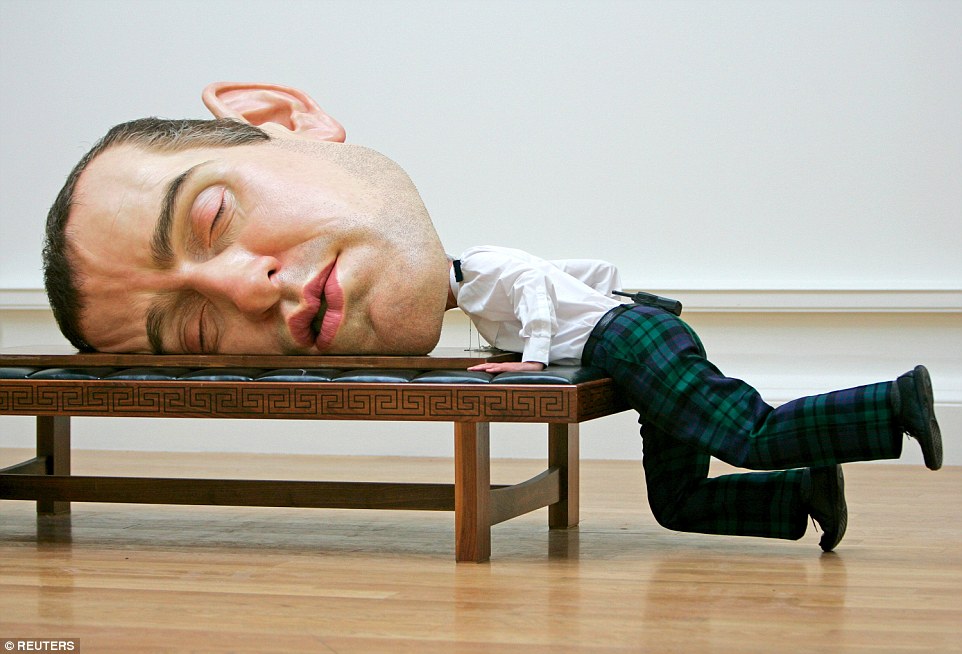 Sleepy head: A security guard jokingly inspects the back of a self-portrait called 'Mask II' by Australian sculptor Ron Mueck at the Royal Scottish Academy in Edinburgh, Scotland, in July 2006