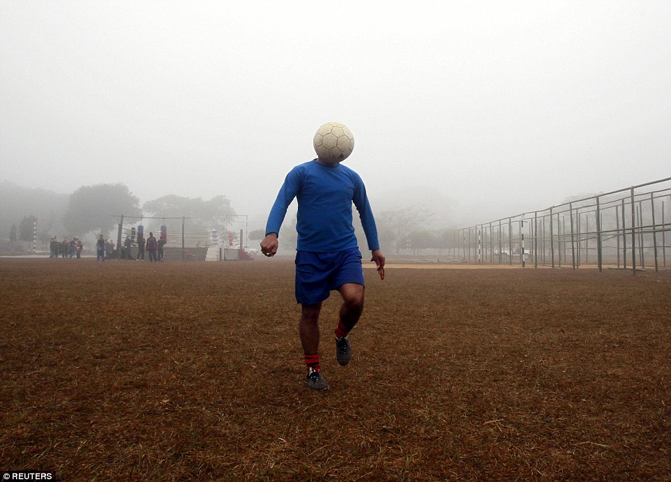 Ball-faced: A man controls a ball during soccer practice in a public park on a foggy morning in Agartala, India, in January 2015