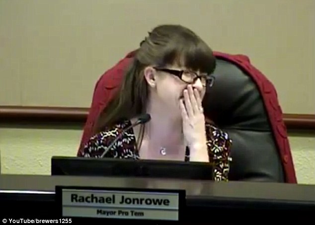 Powering through: As the noises of Mayor Ross relieving himself were broadcast in the city council room, Jonrowe tried to suppress her laughter 