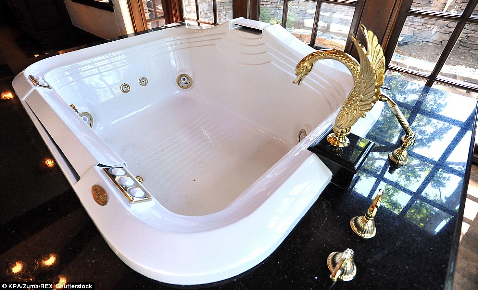 Rest and relaxation: The spa tub in the master bedroom features an ornate swan faucet and a view of the outdoors 
