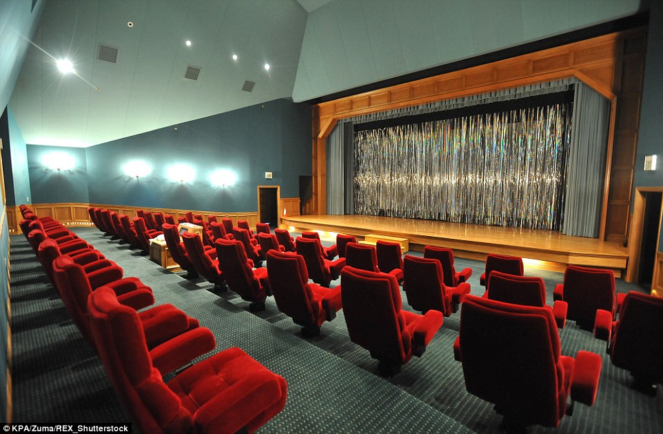 Let the show begin! The home movie theatre (pictured 2009) boasts rows of cushy red velvet chairs and a wooden stage 