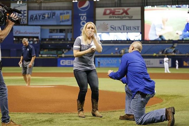 When it came time to throw the real pitch, she noticed something on the game ball. There was a message: "Will you marry me?"