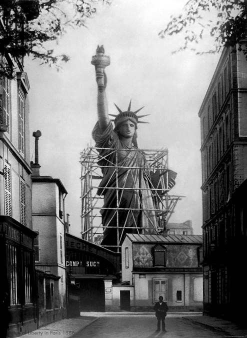The Statue of Liberty being built in Paris. She was built and disassembled in France prior to arriving in New York in 1885.