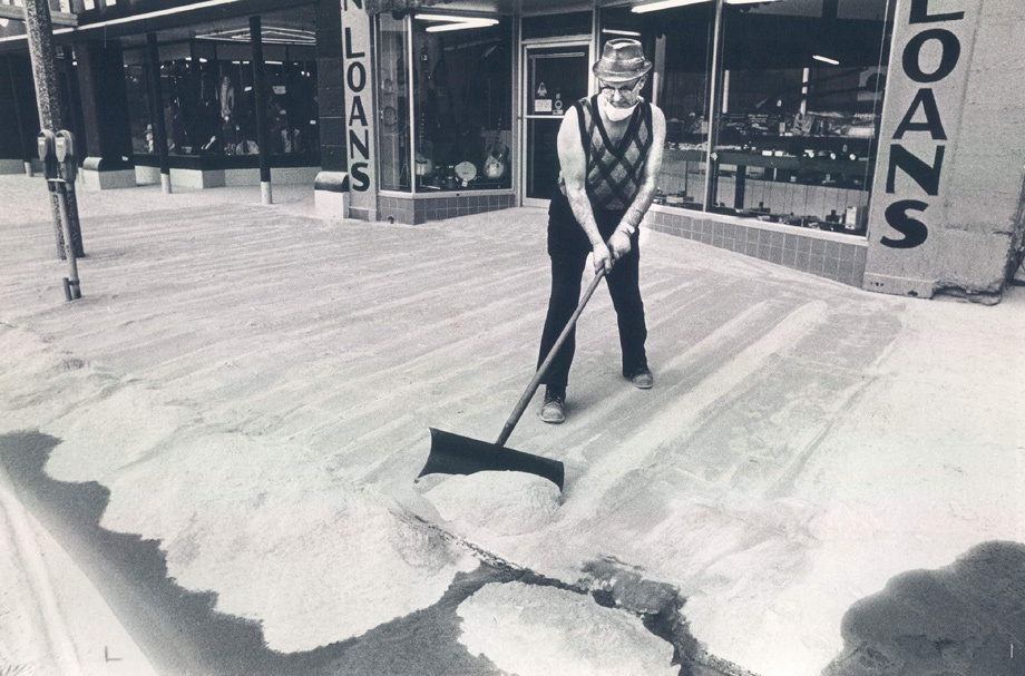 Mike Clinton shovelling volcanic ash off the sidewalk from Mount St. Helens. The volcano in Yakima, Washington erupted on May 18, 1920.