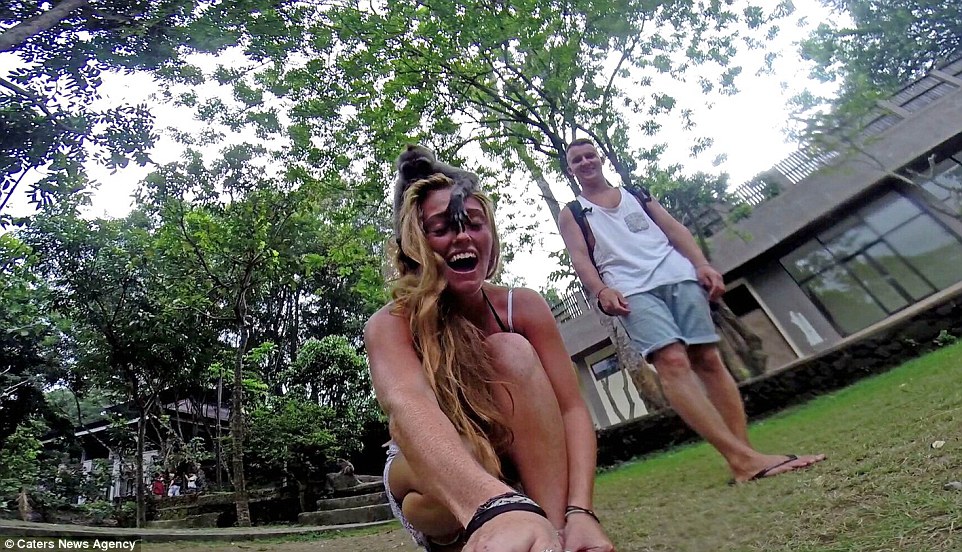 The 23-year-old, who travelled with her partner, Ben Holmes, flipped the camera as a second monkey hopped on top of her head