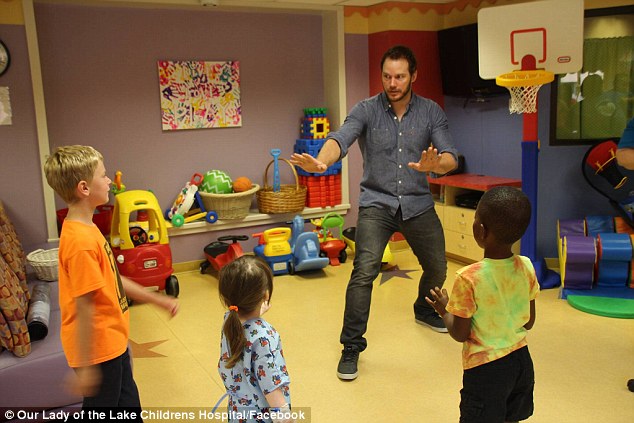 Passing on his skills: Chris Pratt taught some special kids how to train dinosaurs on Saturday at the Our Lady of the Lake Children's Hospital in Louisiana 