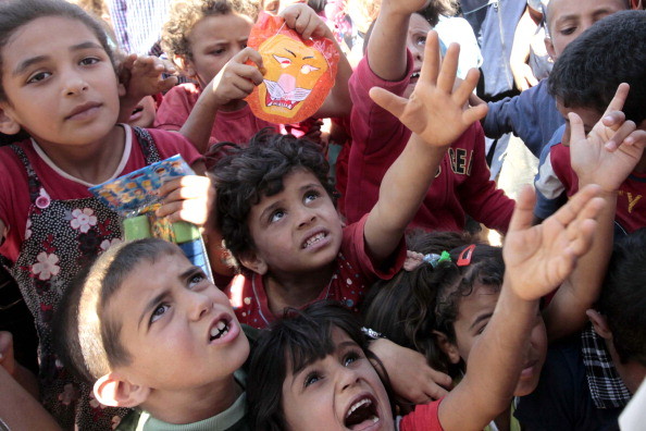 Children in Zaatari receive toys provided by an aid organization on Eid al-Fitr, which falls at the end of Ramadan.