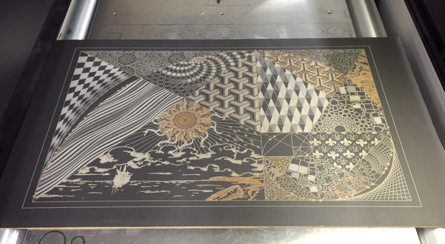 The finished product is called <em>After Sunset</em>. These designs are intricately etched into a slab of slate.