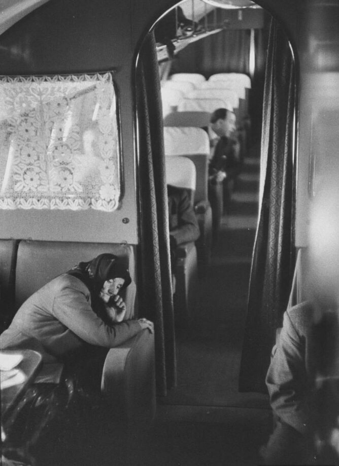 A woman resting inside a Soviet passenger plane in 1957.