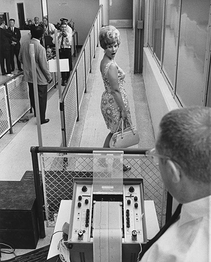 Testing a new  security machine at the Atlanta airport in 1960.