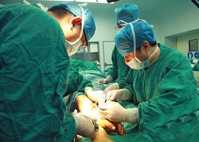 After succesful surgery to reattach the hand (pictured), Zhou is now able to move his fingers slightly. In time it is hoped he will regain full function of his hand