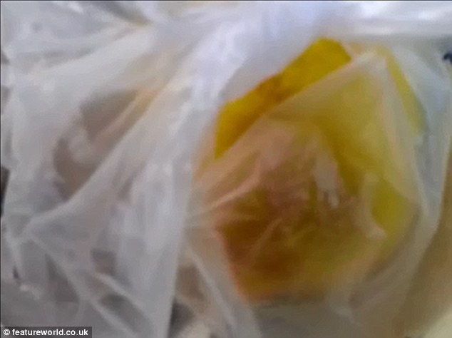 Struggle: A yellow chick moves around inside a plastic bag, waiting to be sold as a child's toy on the beach
