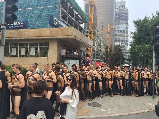 Dozens, if not hundreds, of cute half-naked guys in Spartan costumes showed up in downtown Beijing on Wednesday.