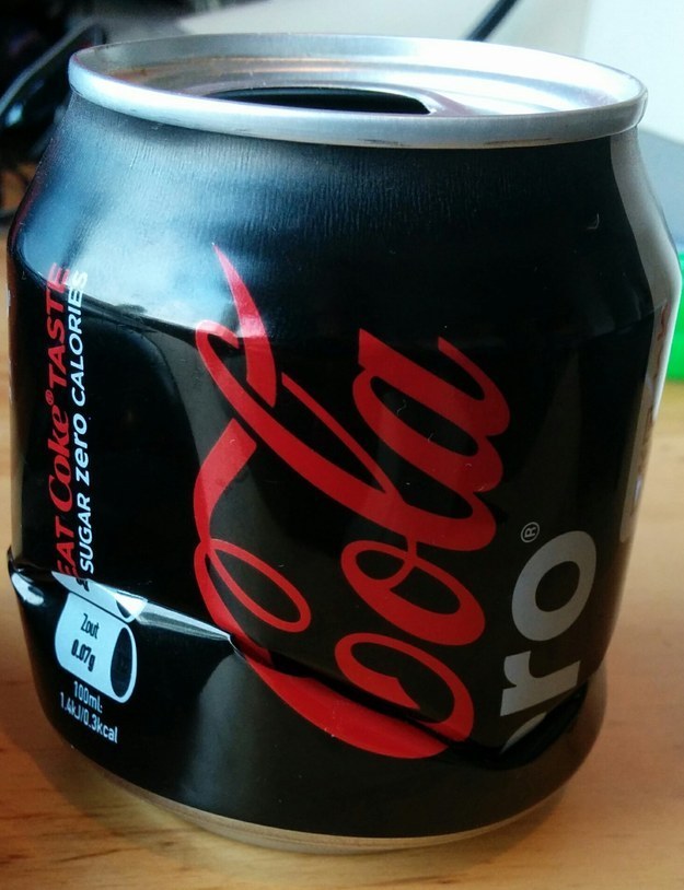 A Coke Zero can that couldn't have been crushed any better.
