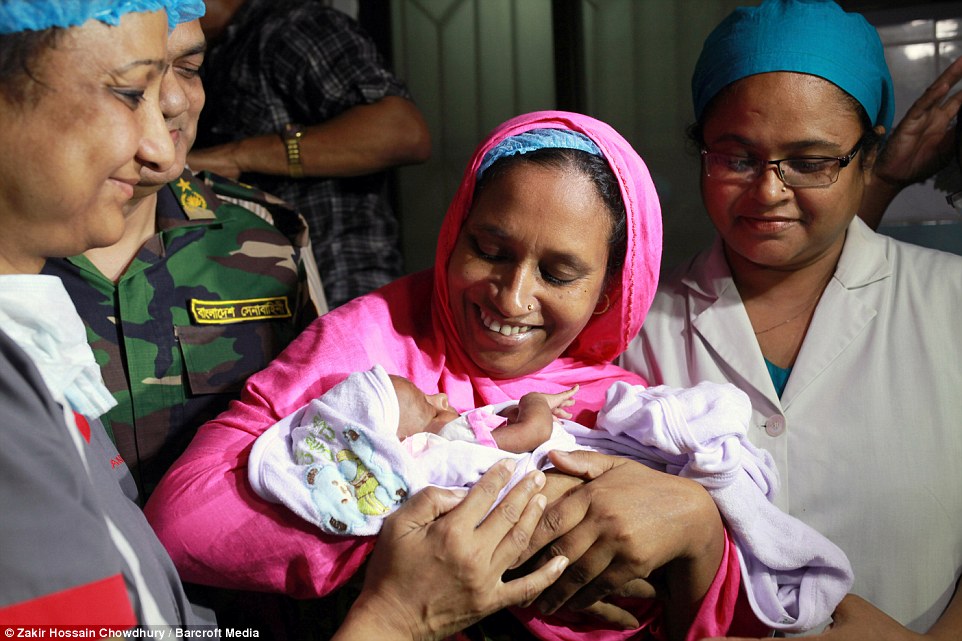 Miracle baby: One-month-old Suraiya, who was hit by a bullet in the womb when her mother was shot during a clash between two militant organisations, is finally reunited with her mother at  Najma in Dhaka, Bangladesh