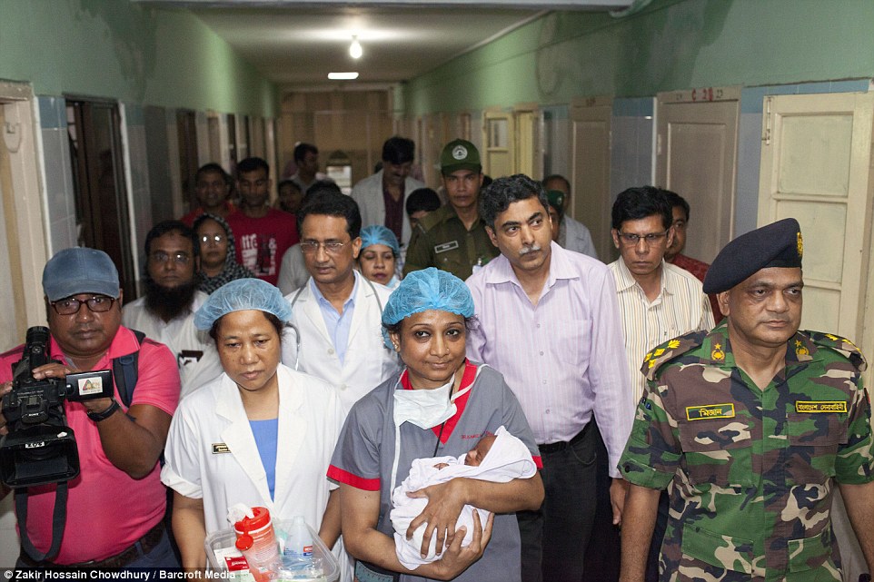 Happy day: Medical staff carry Suraiya to meet her mother as she is being shifted to general ward from the intensive care unit