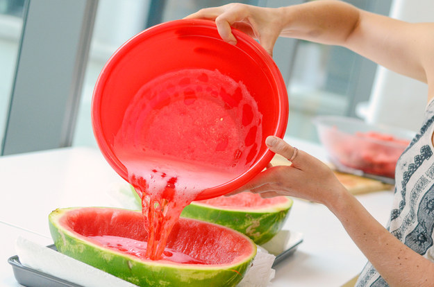 Now, divide the Jell-O mixture between the watermelon bowls on the paper towel-lined trays.