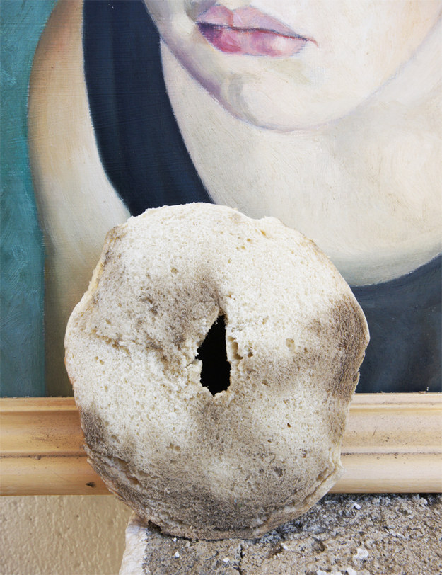 Rub down old paintings with half a bagel.