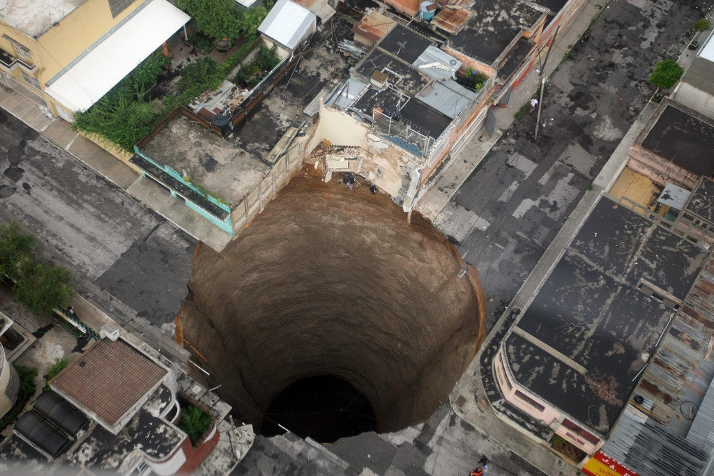 An actual sinkhole in Guatemala City in 2010. It is 60 feet wide and 200 feet deep.