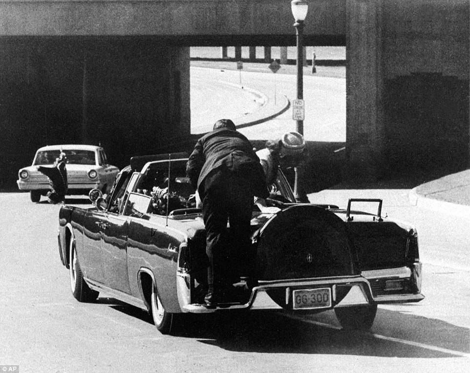 November 22, 1963 - the day President John F Kennedy was assassinated in Dallas, Texas. In this image, he is slumped down in the back seat of the presidential limousine as it speeds along Elm Street after the fatal shooting that shook the world. His wife Jacqueline leans over him as Secret Service agent Clinton Hill rides on the back of the car. Young, charismatic and wealthy, JFK's grip on America's psyche endures to this day, as do the many conspiracy theories surrounding his death